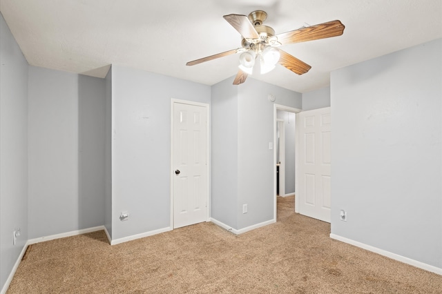 unfurnished bedroom featuring ceiling fan and light carpet