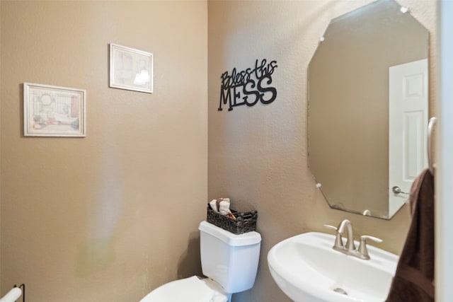 bathroom featuring sink and toilet