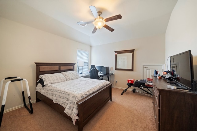 carpeted bedroom with ceiling fan and vaulted ceiling