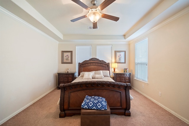 bedroom featuring ceiling fan, a raised ceiling, and light colored carpet