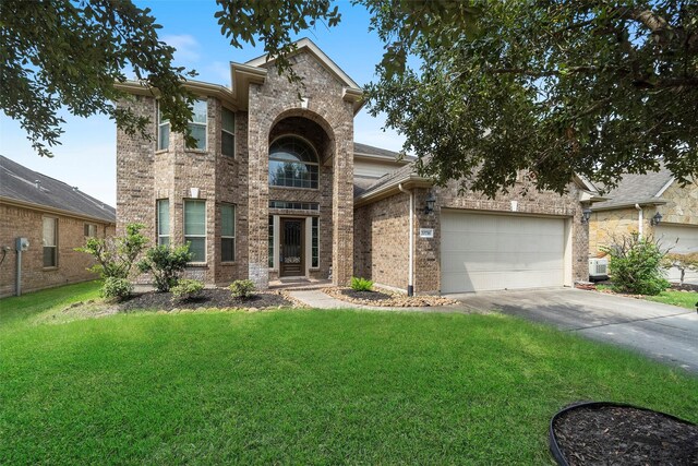 view of front of home with a front lawn and a garage