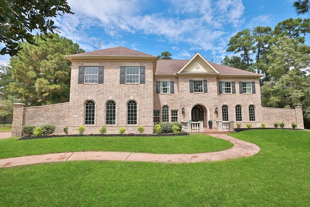 colonial inspired home with a front lawn