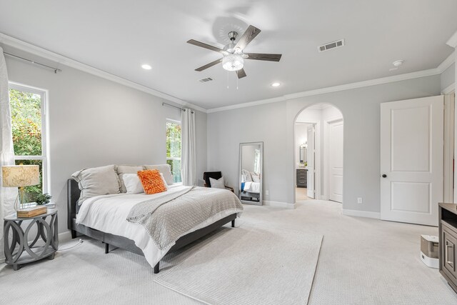 carpeted bedroom featuring multiple windows, crown molding, and ceiling fan