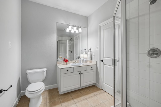 bathroom featuring tile patterned flooring, a shower with door, vanity, and toilet