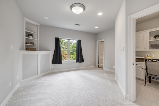 empty room featuring light colored carpet