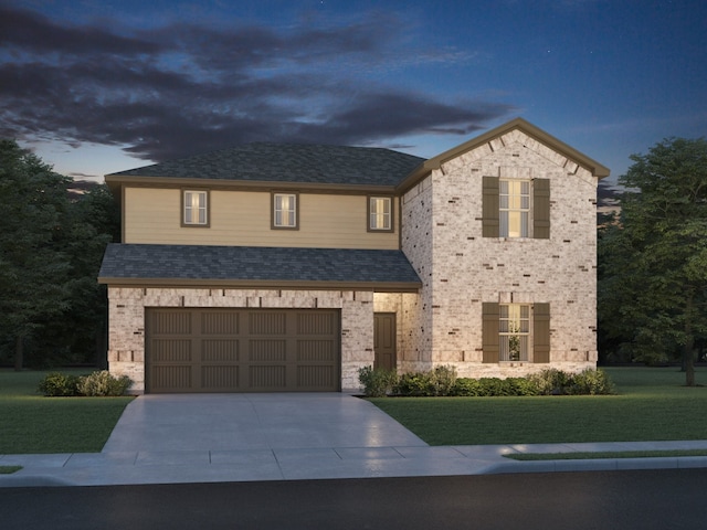 view of front of house featuring a garage, driveway, a front lawn, and brick siding