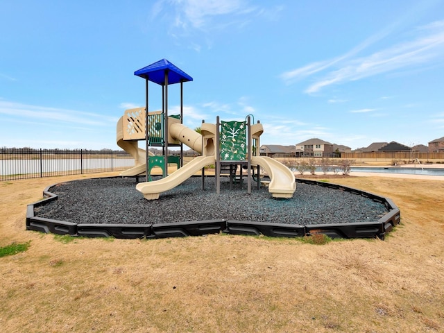 community playground featuring fence and a lawn