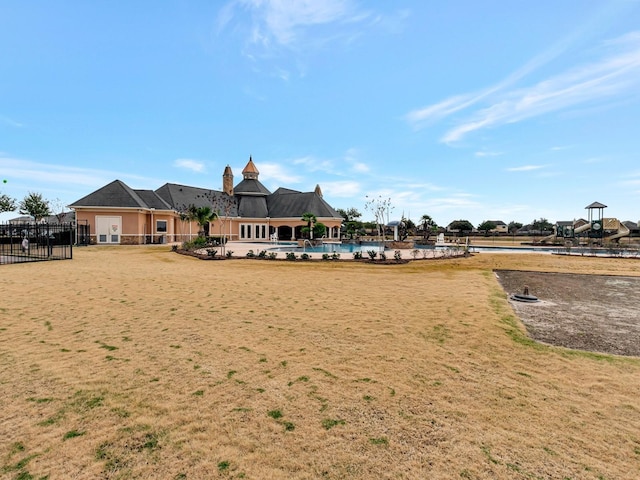 surrounding community with a yard and a swimming pool