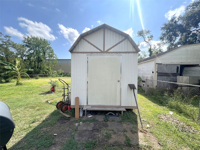 view of outbuilding with a lawn