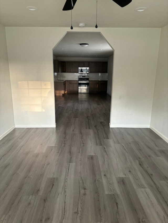 hallway featuring sink and hardwood / wood-style floors