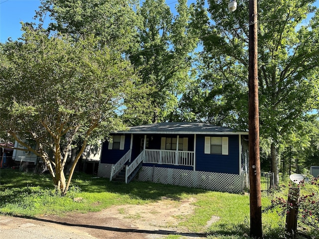 view of front of home with a front yard and covered porch