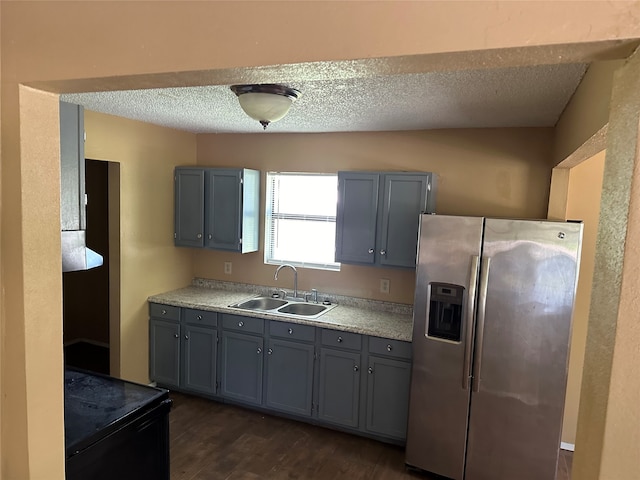 kitchen featuring sink, black range with electric stovetop, dark wood-type flooring, gray cabinetry, and stainless steel fridge with ice dispenser