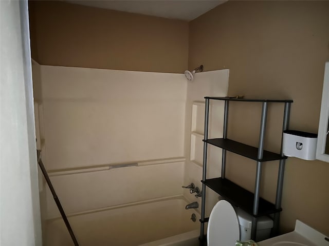 bathroom featuring toilet and shower / tub combination