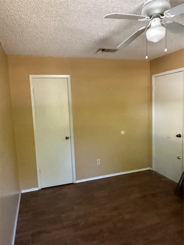 interior space featuring ceiling fan, hardwood / wood-style flooring, and a textured ceiling