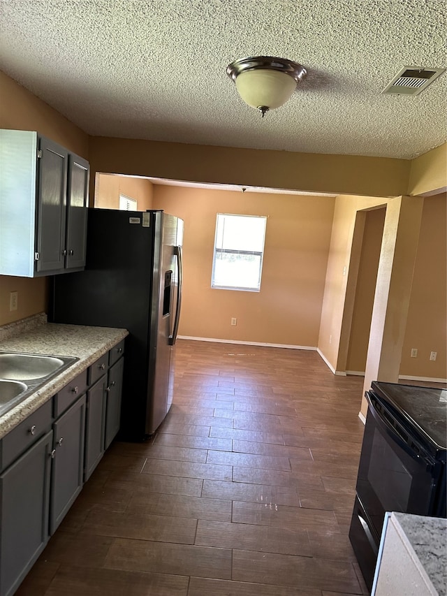 kitchen with sink, electric range, dark hardwood / wood-style flooring, and gray cabinetry