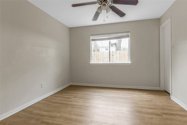 empty room with light wood-type flooring, baseboards, and a ceiling fan