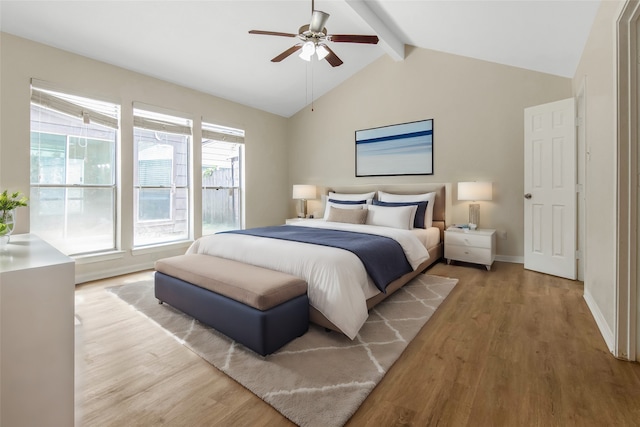 bedroom featuring ceiling fan, light hardwood / wood-style floors, and lofted ceiling with beams