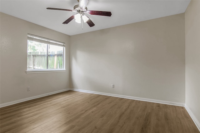 unfurnished room featuring ceiling fan and hardwood / wood-style flooring