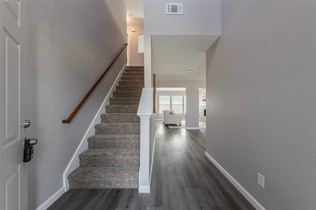 stairway with hardwood / wood-style flooring