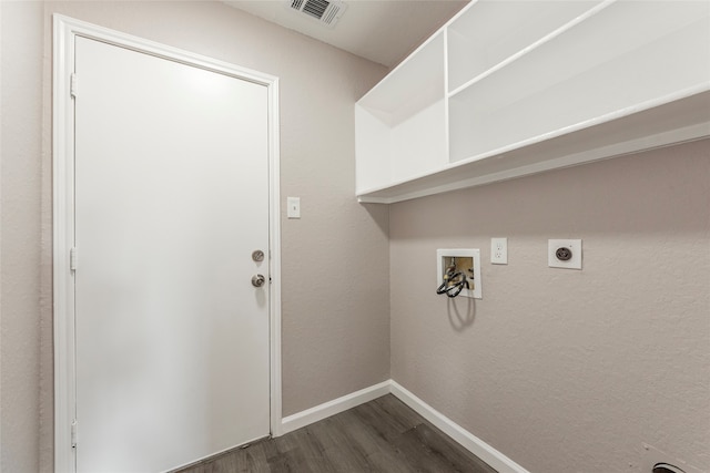 clothes washing area with hookup for an electric dryer, dark hardwood / wood-style floors, and washer hookup