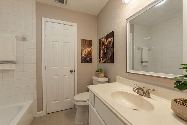 full bathroom featuring tiled shower / bath combo, tile patterned floors, toilet, and vanity