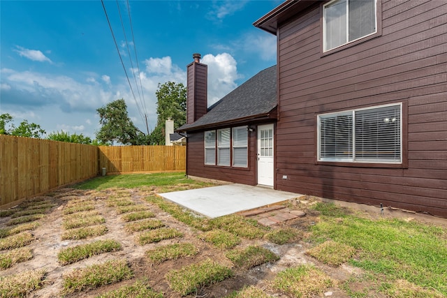 rear view of house with a patio area and a yard