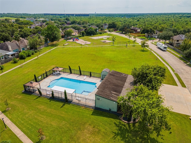 view of pool with a yard