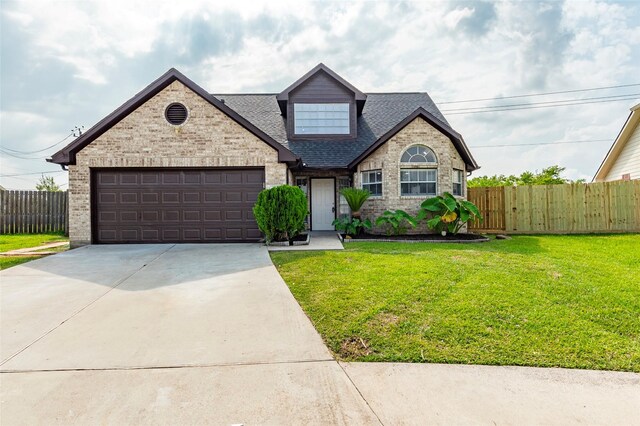 view of front of home with a garage and a front yard