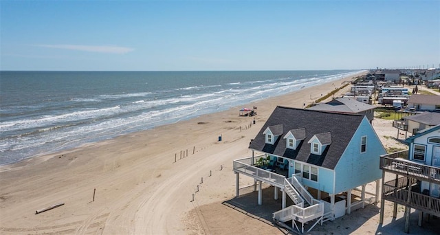 bird's eye view featuring a water view and a beach view