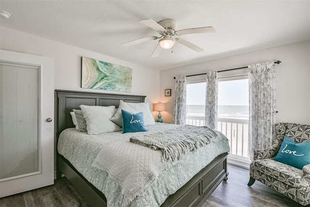 bedroom with ceiling fan, access to outside, and dark wood finished floors