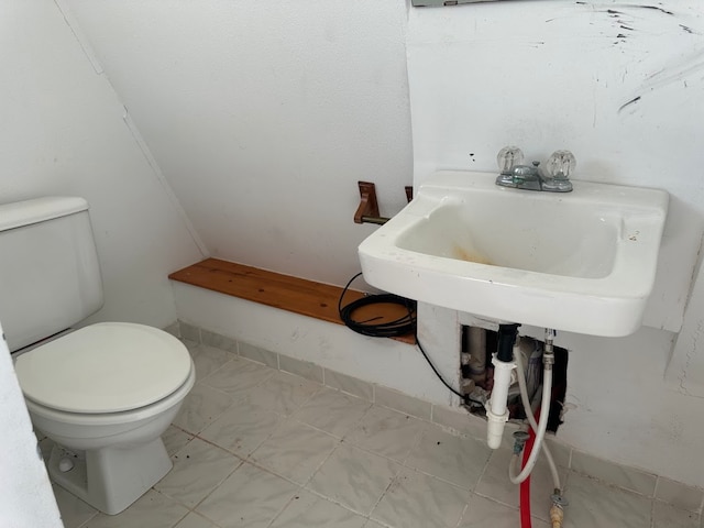 bathroom with toilet and tile patterned floors