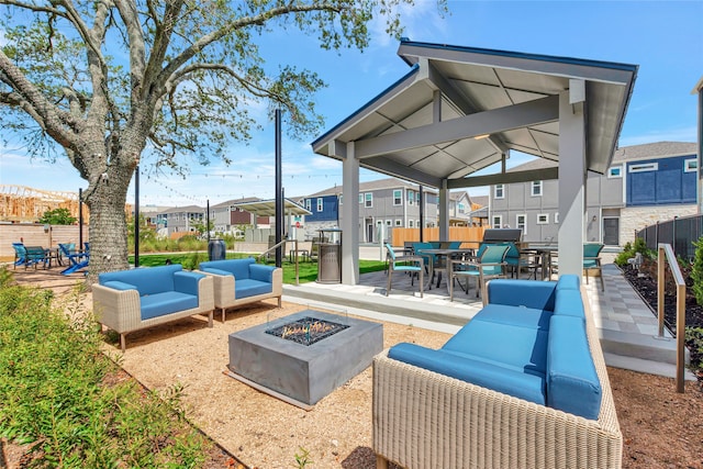 view of patio / terrace with an outdoor living space with a fire pit