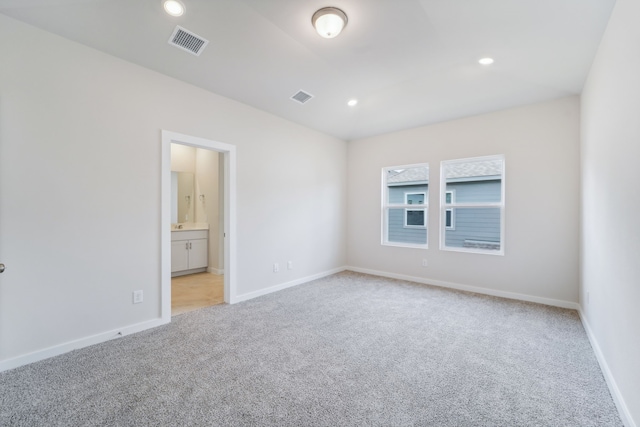 unfurnished room featuring light carpet