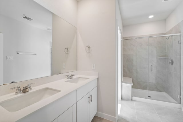 bathroom featuring tile patterned flooring, vanity, and walk in shower