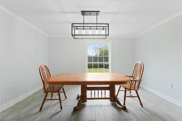 dining room with a notable chandelier, hardwood / wood-style floors, and crown molding