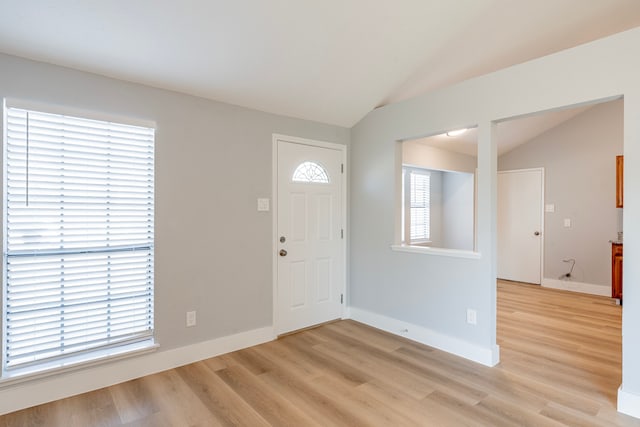 foyer entrance featuring light hardwood / wood-style flooring and lofted ceiling