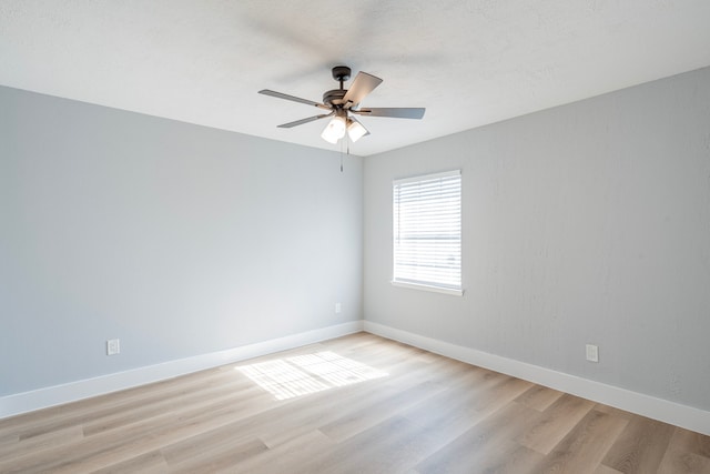 unfurnished room with ceiling fan and light wood-type flooring