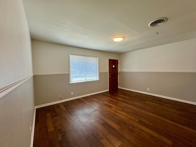 empty room featuring dark hardwood / wood-style flooring