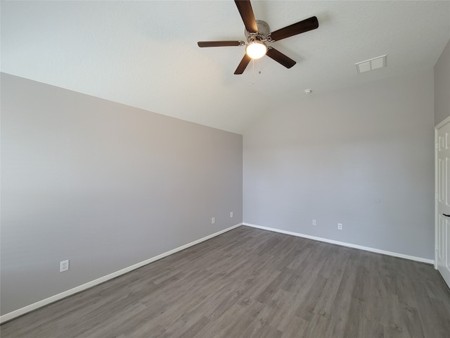 unfurnished room featuring vaulted ceiling, dark hardwood / wood-style flooring, and ceiling fan