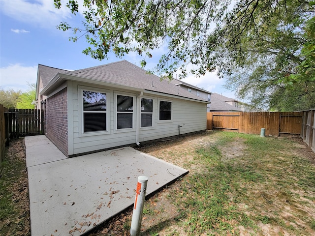 rear view of house featuring a patio and a yard