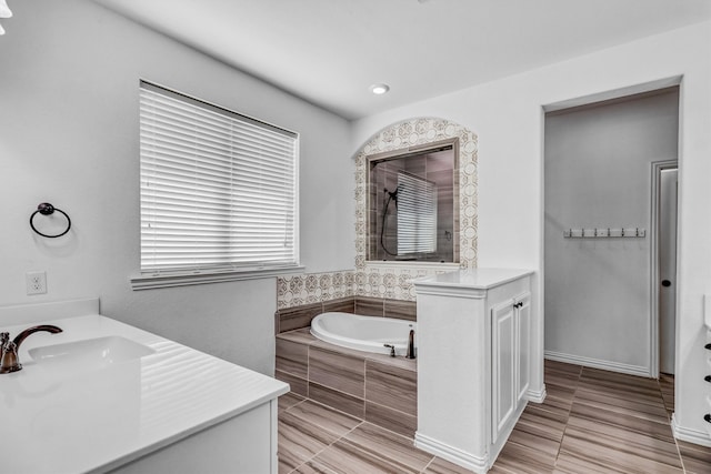 bathroom with a relaxing tiled tub