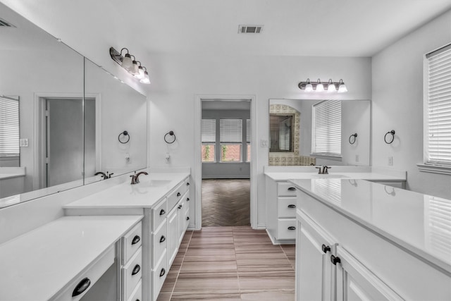 bathroom with tile patterned floors, plenty of natural light, and vanity