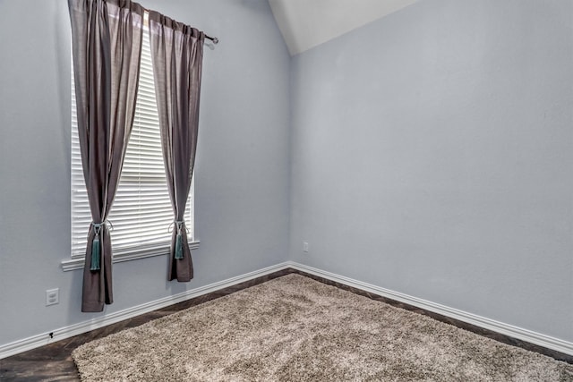 unfurnished room featuring carpet, plenty of natural light, and lofted ceiling