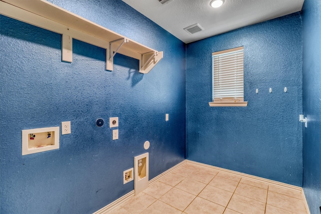 clothes washing area with electric dryer hookup, tile patterned flooring, and washer hookup