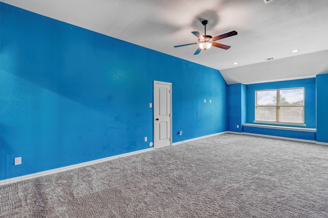 carpeted empty room featuring ceiling fan and vaulted ceiling