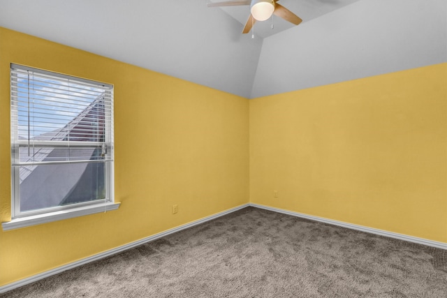 carpeted spare room with ceiling fan and lofted ceiling