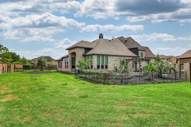 back of house featuring a lawn