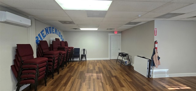 living room with a drop ceiling and dark wood-type flooring