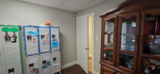 rec room with hardwood / wood-style floors and a drop ceiling