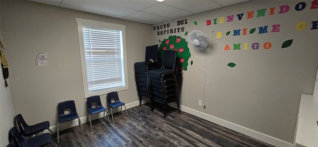 miscellaneous room featuring a drop ceiling and hardwood / wood-style flooring